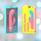 A B Swish Bwild Classic Marine Rabbit Vibrator in Guava with a G-Spot loving shaft is shown. The silicone rabbit massager, pink in color, is displayed out of its packaging on the left and in its packaging on the right. The background features abstract, soft-focus colorful lights.